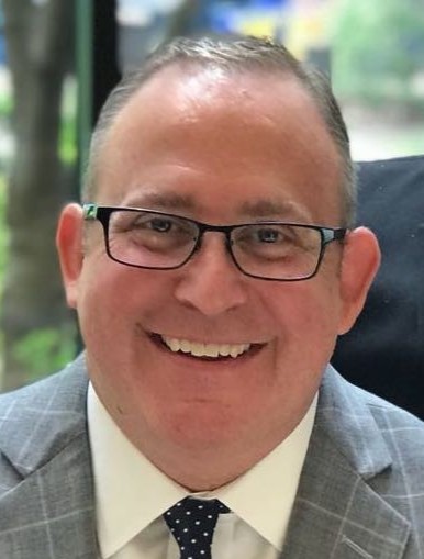 Headshot of Michael Bennett, founder of BGS wearing a suit